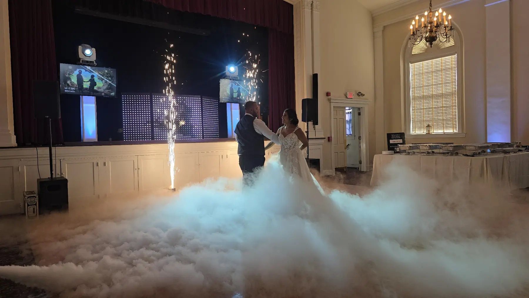 Novios bailando sobre nubes con fuentes de pirotecnia fría