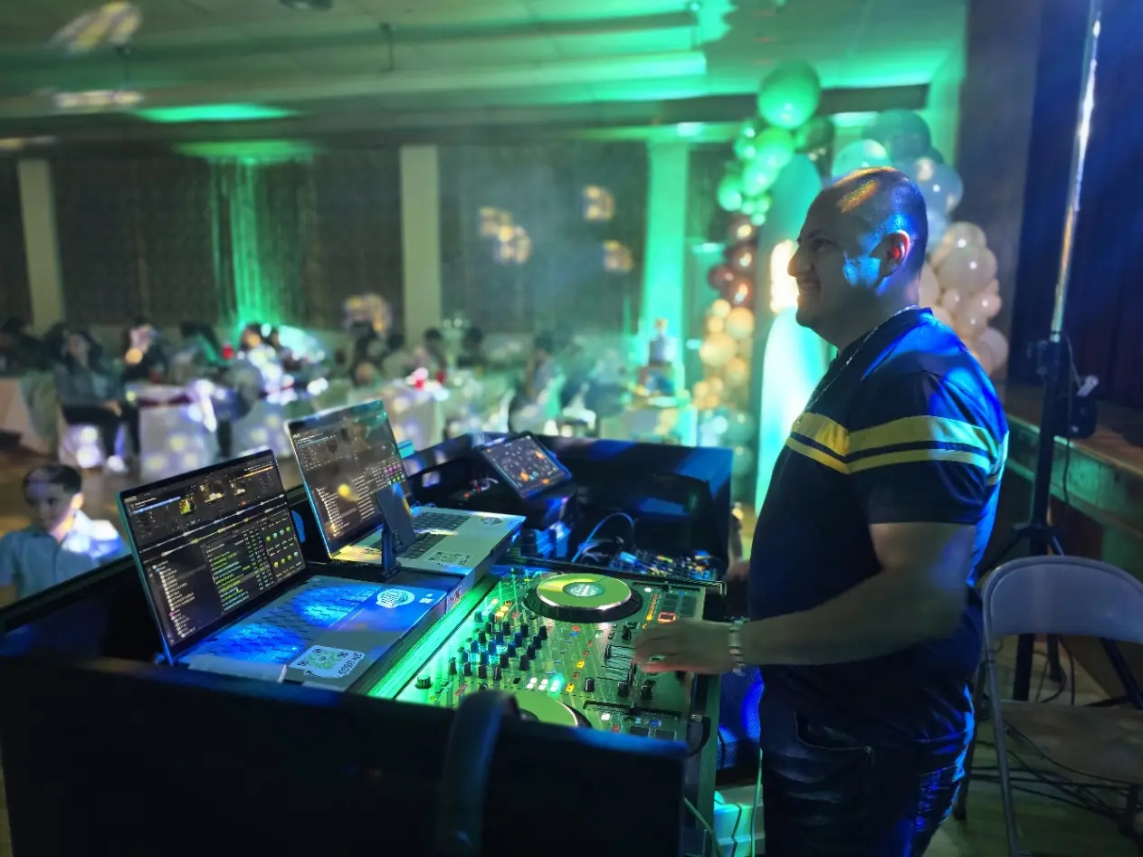 DJMIX operando la cabina bajo iluminación verde y azul